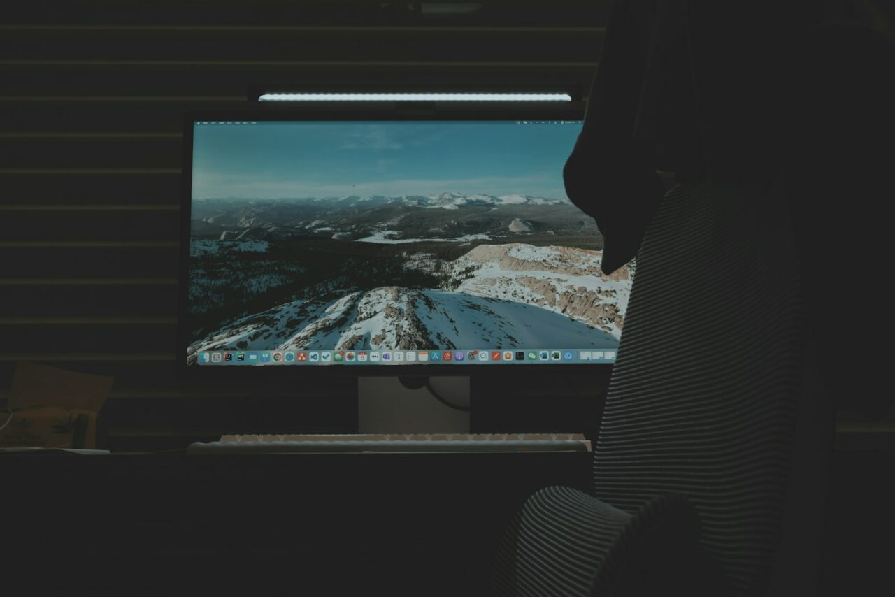 a computer monitor sitting on top of a desk